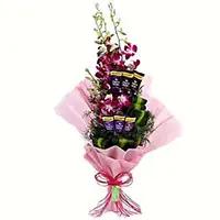 Same Day New Year Chocolates to Vizag containing 12 Red Roses 5 Ferrero Rocher Bouquet