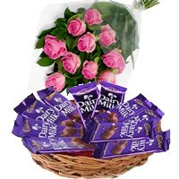 Deliver New Year Gifts in Hyderabad consisting Dairy Milk Basket 12 Chocolates With 12 Pink Roses in Hyderabad