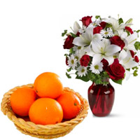 Send Diwali Gifts to Hyderabad Same Day Delivery contain of 2 White Lily 6 White Gerbera 6 Red Roses Vase with 12 pcs Fresh Orange Basket