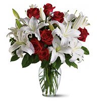 Same Day New Year Flowers in Hyderabad that contains 4 White Lily 12 Red Roses Vase