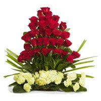 Deliver Valentine's Day Flowers inn Hdyerabad having 50 Red Roses 25 Yellow Carnations Flower Basket to Rajahmundry