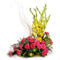 Valentine's Day Flowers Basket to Hyderabad. 18 Pink Carnation 6 Yellow Glad Flower Basket