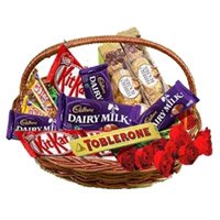 Send Christmas Flowers to Hyderabad. Basket of Assorted Chocolate and 10 Red Roses to Hyderabad