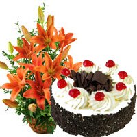 New Year Gifts Delivery in Vizag having 12 Orange Lily Arrangement 1 Kg Black Forest Cake in Hyderabad